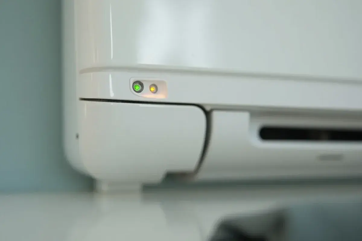 Close view of blinking indicator lights on the front of a wall-mounted ductless head